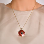 Necklace with a red pendant on a neutral background